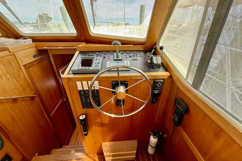 Slide: The Image of 2001 Sabre Sabreline 34 helm with wooden finish and navigation controls. - 35
