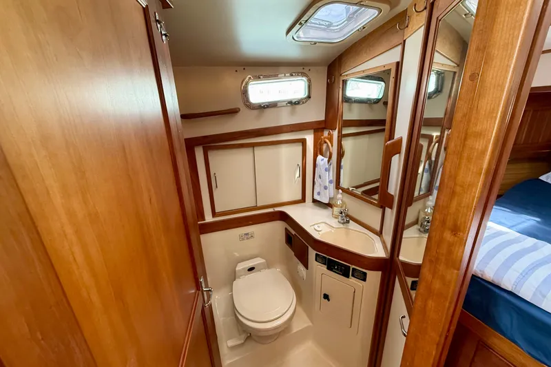 Slide: The Image of 2001 Sabre Sabreline 34 yacht bathroom with wood accents and compact design. - 38