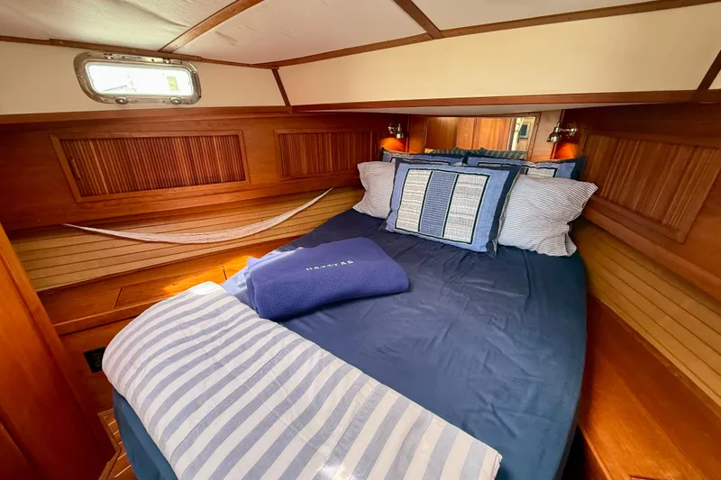 Slide: The Image of Cozy cabin interior of 2001 Sabre Sabreline 34 with nautical bedding and wood paneling. - 41