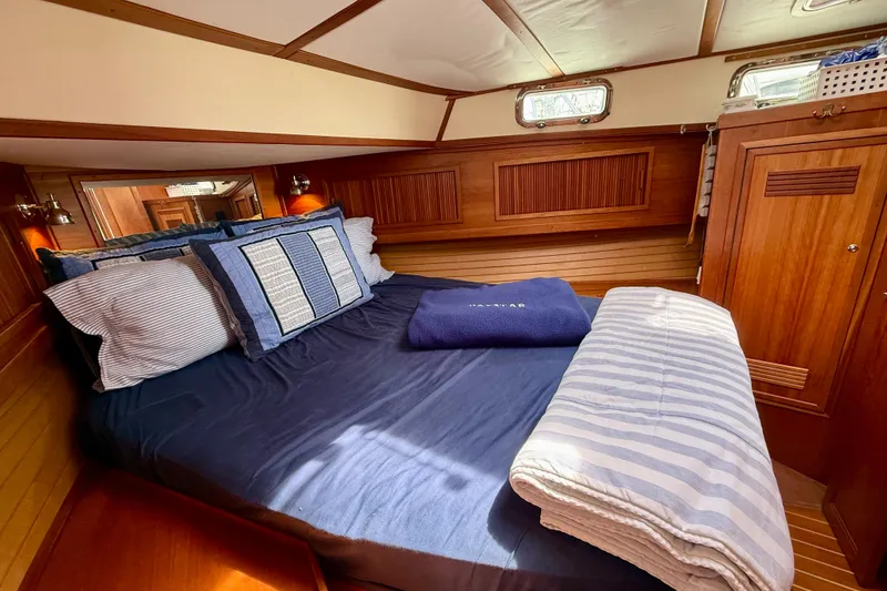Slide: The Image of Cozy cabin interior of 2001 Sabre Sabreline 34 yacht with wooden paneling and comfortable bedding. - 43
