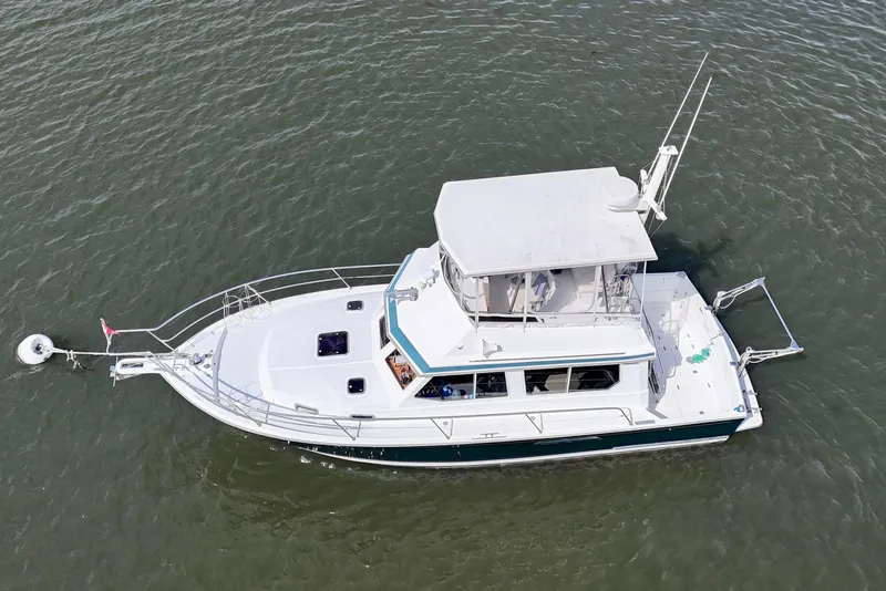 Slide: The Image of 2001 Sabre Sabreline 34 boat on water, aerial view, white and blue design. - 5