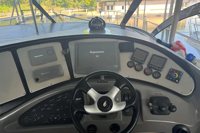 Slide: The Image of 2006 Cruisers Yachts 560 Express helm with Raymarine navigation system and controls. - 10