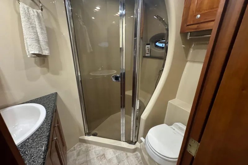 Slide: The Image of Luxurious bathroom in 2006 Cruisers Yachts 560 Express with shower and modern amenities. - 17