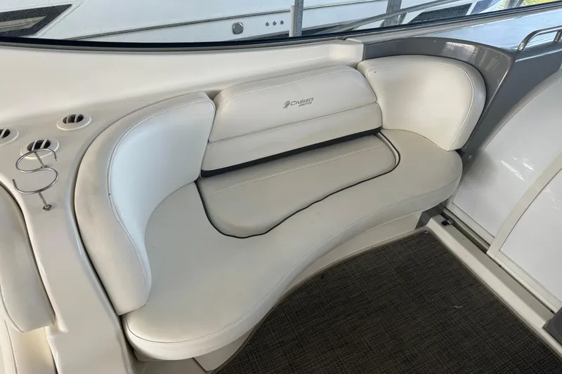 Slide: The Image of 2006 Cruisers Yachts 560 Express interior seating with white leather upholstery. - 6