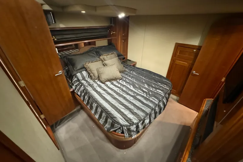 Slide: The Image of Luxurious bedroom interior of 2006 Cruisers Yachts 560 Express with elegant bedding. - 12