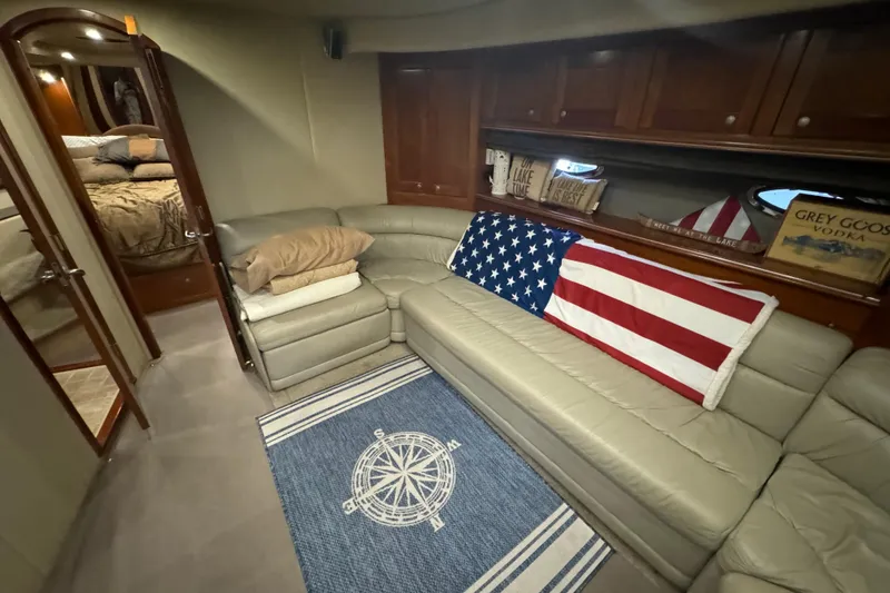 Slide: The Image of Luxurious 2006 Cruisers Yachts 560 Express interior with American flag decor and cozy seating. - 16