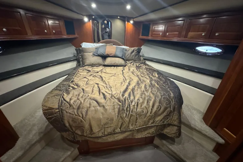 Slide: The Image of Luxurious 2006 Cruisers Yachts 560 Express cabin with elegant bedding and wood cabinetry. - 20