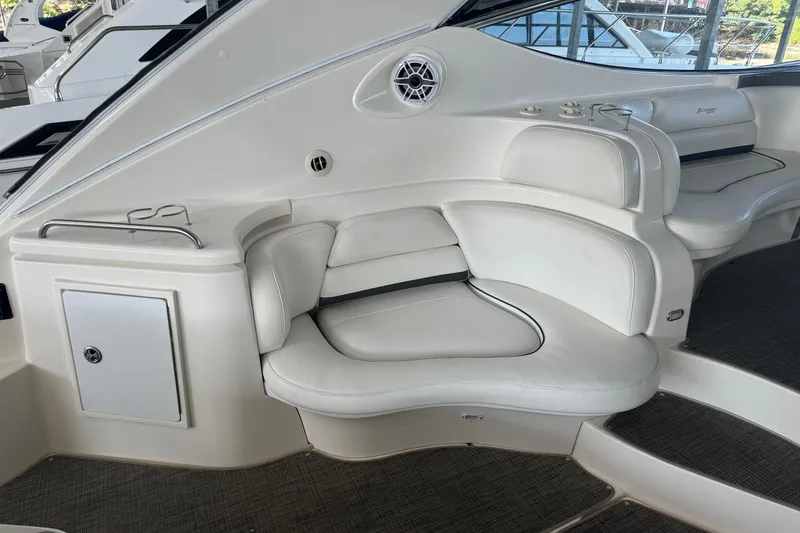 Slide: The Image of 2006 Cruisers Yachts 560 Express interior seating with white leather upholstery and modern design. - 8