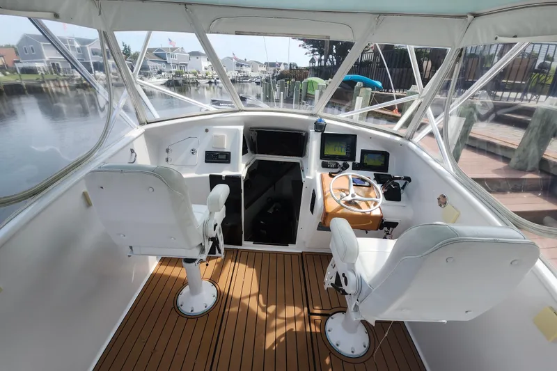 Slide: The Image of 2003 Shearline 30 Express boat cockpit with dual seats and navigation equipment. - 14