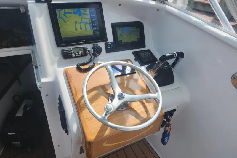 Slide: The Image of Helm of 2003 Shearline 30 Express boat with navigation screens and controls. - 20