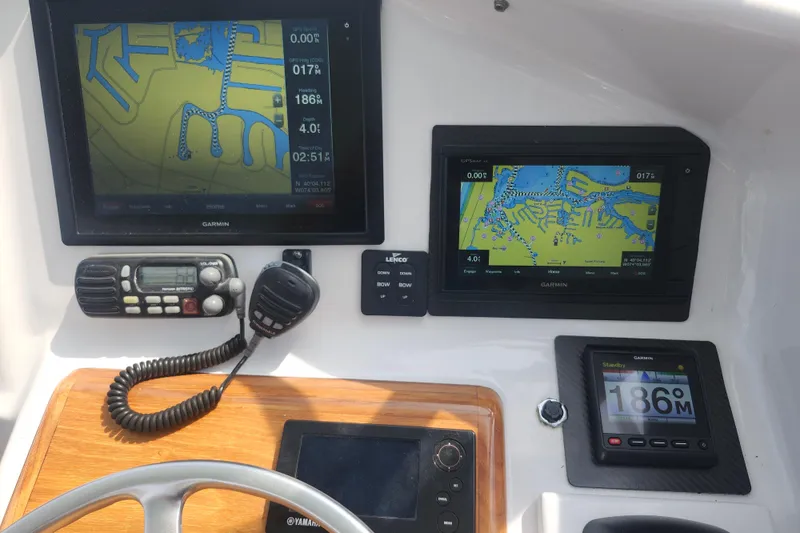 Slide: The Image of Boat dashboard with Garmin navigation displays on a 2003 Shearline 30 Express. - 21