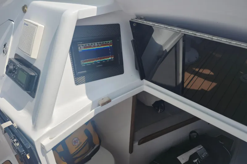 Slide: The Image of 2003 Shearline 30 Express boat dashboard with Garmin GPS and radio equipment. - 22