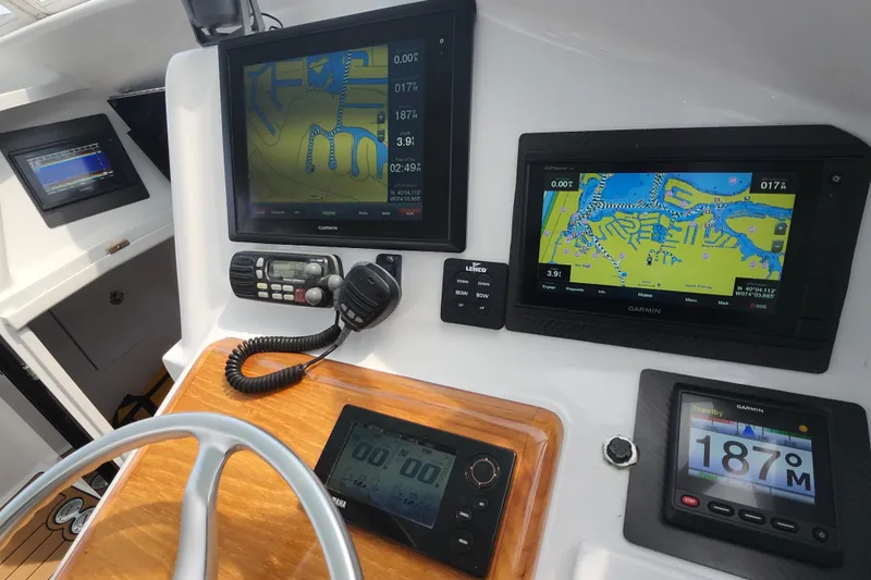 Slide: The Image of Control panel of a 2003 Shearline 30 Express boat with navigation screens and controls. - 24