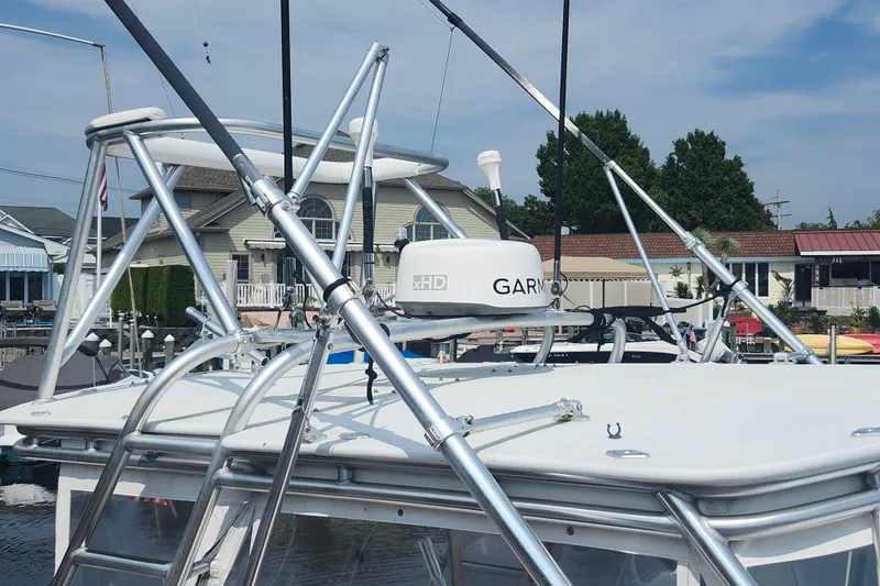 Slide: The Image of 2003 Shearline 30 Express boat with radar equipment docked near houses. - 28