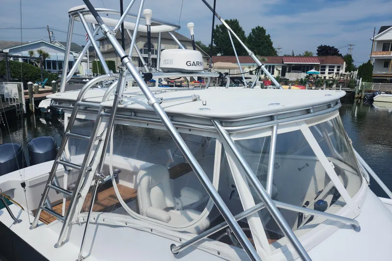 Slide: The Image of 2003 Shearline 30 Express boat docked, featuring a sleek design and sturdy framework. - 29