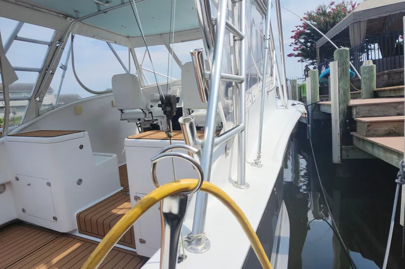 Slide: The Image of 2003 Shearline 30 Express boat docked, featuring sleek design and modern interior. - 30