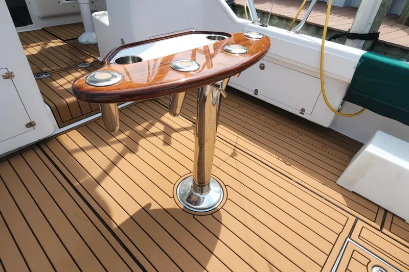 Slide: The Image of 2003 Shearline 30 Express boat deck with polished wood table and stainless steel fittings. - 35