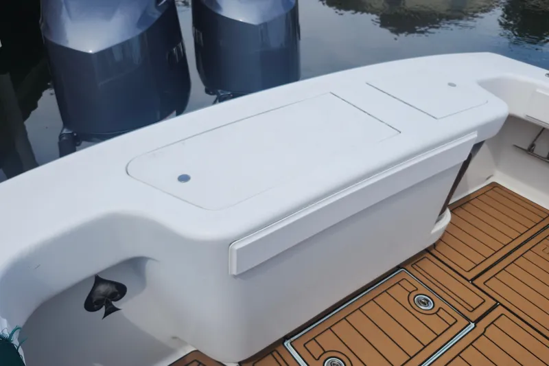 Slide: The Image of 2003 Shearline 30 Express boat deck with dual outboard motors and teak flooring. - 37