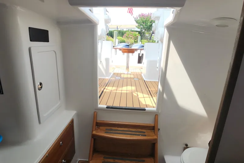 Slide: The Image of Interior view of 2003 Shearline 30 Express boat, featuring wooden steps and deck. - 38