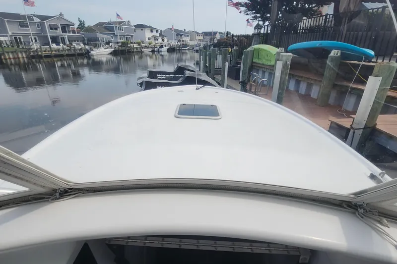 Slide: The Image of 2003 Shearline 30 Express boat docked in a residential canal setting. - 39