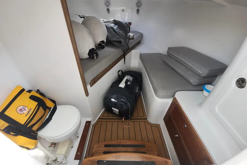 Slide: The Image of 2003 Shearline 30 Express cabin interior with seating, storage, and marine toilet. - 42
