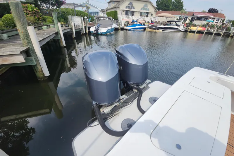 Slide: The Image of 2003 Shearline 30 Express boat with dual outboard motors docked in a marina. - 45