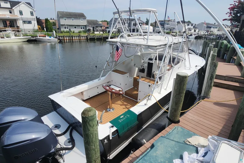 Slide: The Image of 2003 Shearline 30 Express boat docked in a residential canal setting. - 9