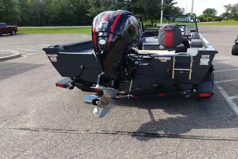 Slide: The Image of 2024 Ranger VS1782SC Angler boat with powerful outboard motor in a parking lot. - 3