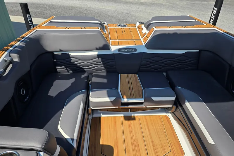 Slide: The Image of Luxurious interior of 2026 Supra SA boat with sleek seating and wood accents. - 12