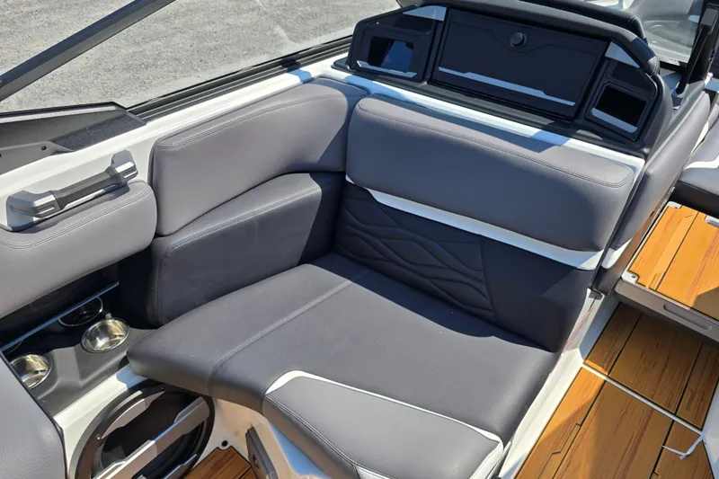 Slide: The Image of 2026 Supra SA boat interior with gray seating and wooden flooring. - 14