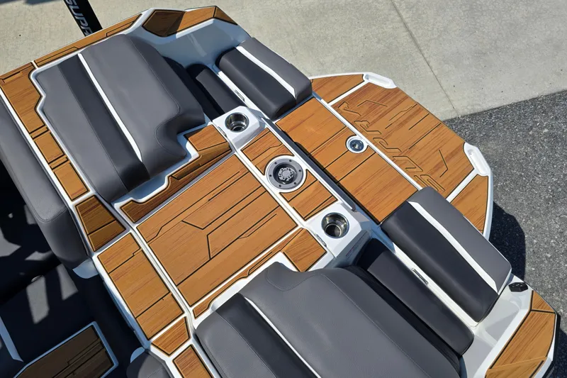 Slide: The Image of 2026 Supra SA boat interior with teak flooring and gray seating, showcasing luxury design. - 18