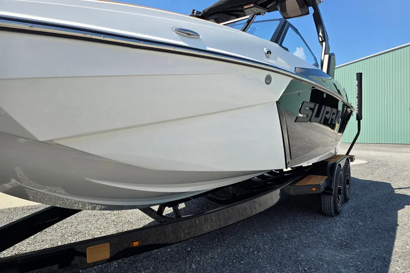 Slide: The Image of 2026 Supra SA boat on trailer, sleek design, parked outdoors. - 3