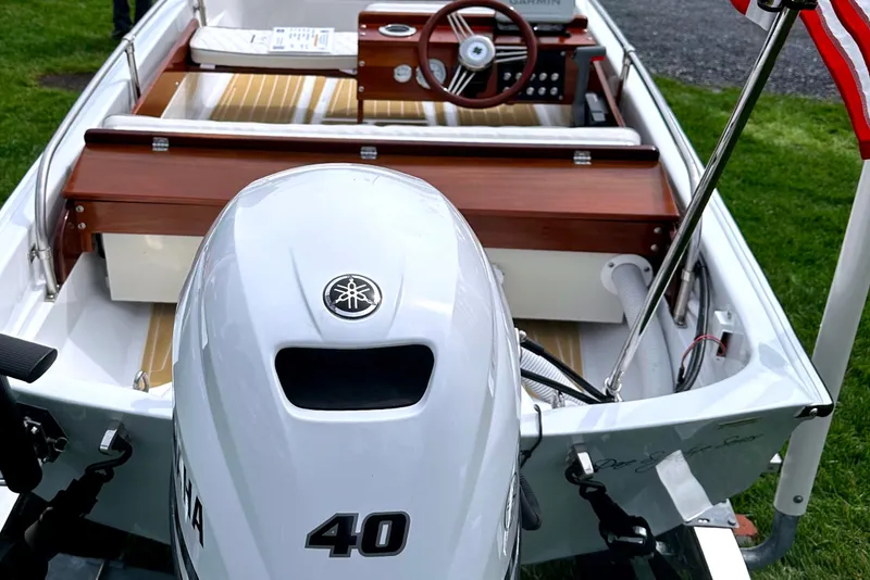 Slide: The Image of 1981 Boston Whaler 13 Super Sport with Yamaha 40 engine, wooden interior, and American flag. - 11