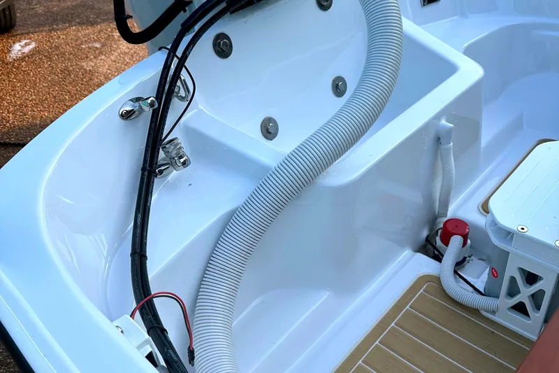 Slide: The Image of Interior view of a 1981 Boston Whaler 13 Super Sport boat, showing cables and compartments. - 14