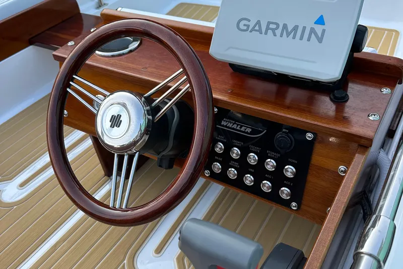 Slide: The Image of 1981 Boston Whaler 13 Super Sport dashboard with Garmin GPS and wooden steering wheel. - 15