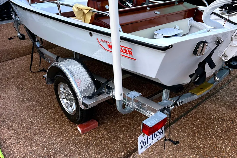 Slide: The Image of 1981 Boston Whaler 13 Super Sport boat on trailer, showcasing classic design and build. - 7