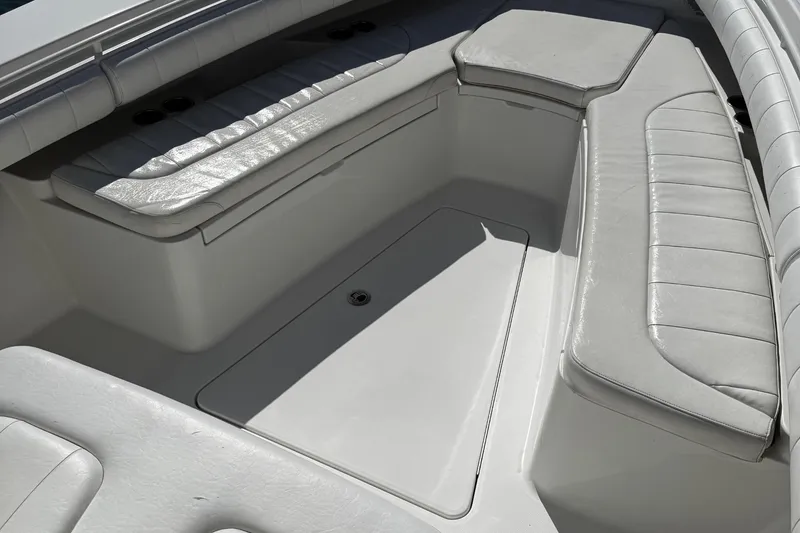 Slide: The Image of 2015 Regulator 28 Forward Seating boat interior with cushioned seats and storage. - 10
