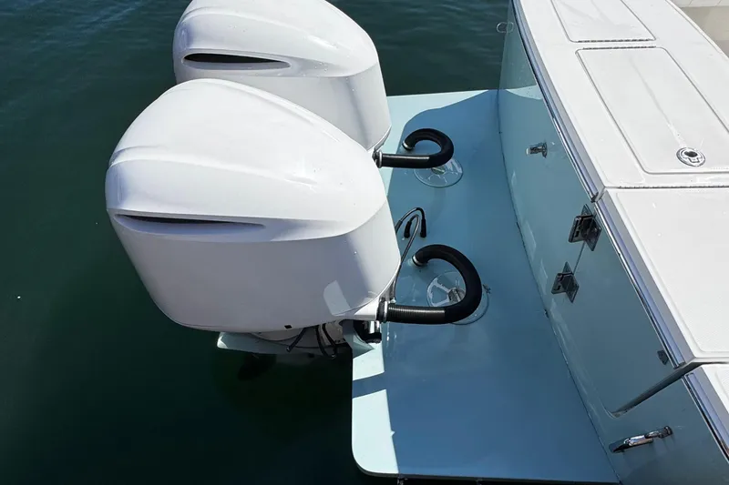 Slide: The Image of 2015 Regulator 28 Forward Seating boat with dual outboard engines on water. - 11