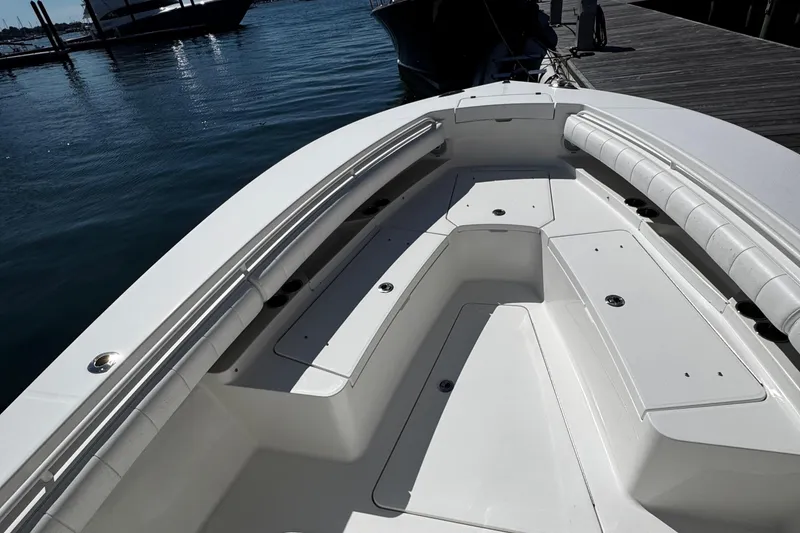 Slide: The Image of 2015 Regulator 28 Forward Seating boat docked, showcasing spacious seating and storage. - 12