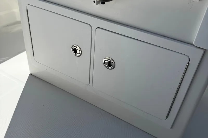Slide: The Image of Storage compartments on a 2015 Regulator 28 Forward Seating boat. - 13