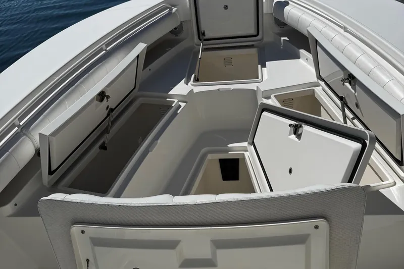 Slide: The Image of 2015 Regulator 28 Forward Seating boat with open storage compartments, showcasing ample space. - 19