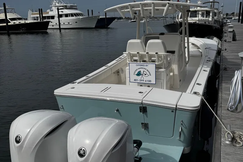 Slide: The Image of 2015 Regulator 28 Forward Seating boat docked with twin engines. - 2