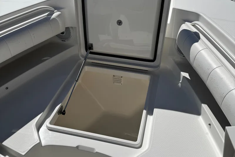 Slide: The Image of 2015 Regulator 28 Forward Seating boat storage compartment open, showcasing interior space. - 20