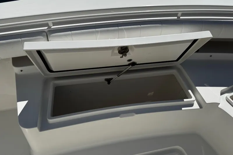 Slide: The Image of Open storage compartment on a 2015 Regulator 28 Forward Seating boat. - 21