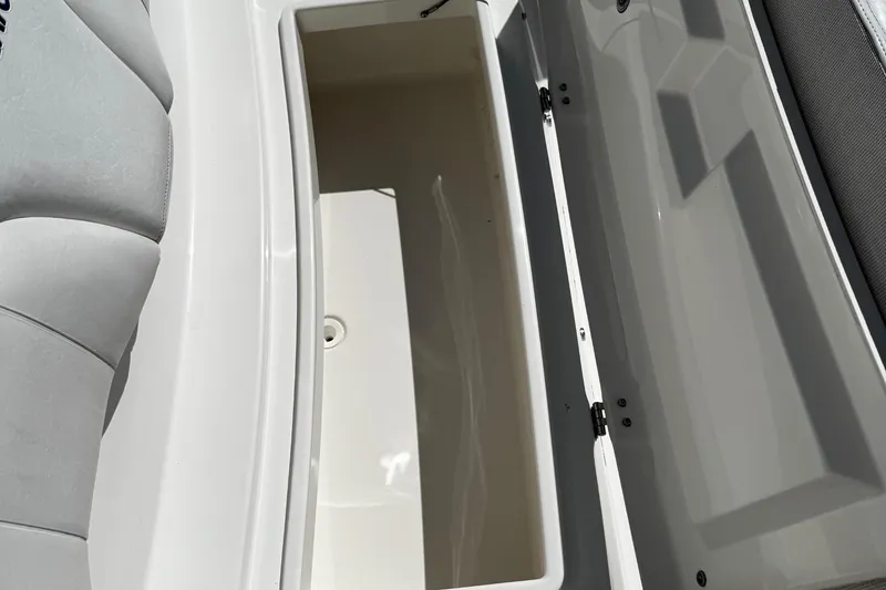 Slide: The Image of 2015 Regulator 28 Forward Seating storage compartment with open lid and cushioned seating. - 22