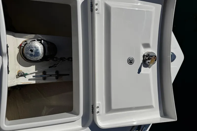 Slide: The Image of 2015 Regulator 28 Forward Seating boat anchor compartment with winch and chain. - 23