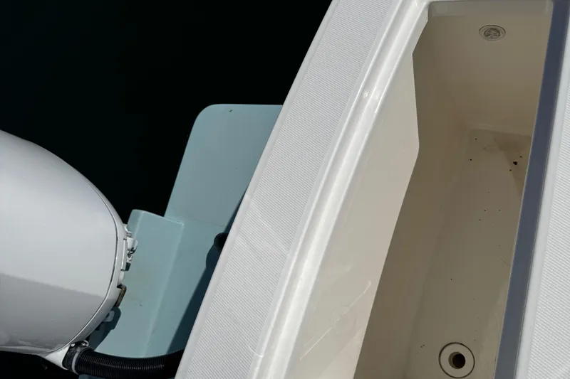 Slide: The Image of 2015 Regulator 28 Forward Seating boat, showing engine and storage compartment. - 26