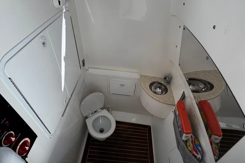Slide: The Image of 2015 Regulator 28 Forward Seating boat interior with toilet and sink. - 27
