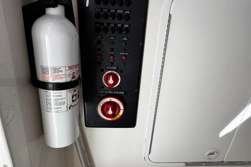 Slide: The Image of 2015 Regulator 28 Forward Seating boat control panel with fire extinguisher. - 29