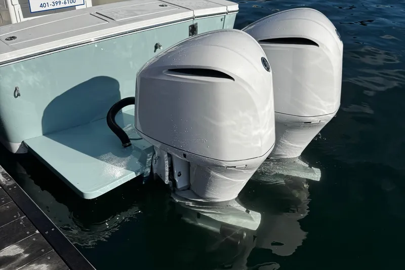 Slide: The Image of 2015 Regulator 28 Forward Seating boat with dual outboard engines in water. - 40